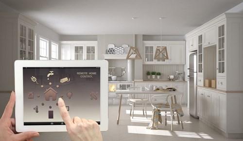 Person uses tablet to access various elements of her home, e.g. lighting, machines